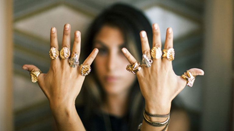 Ashley Porters displays 10 of her ring designs on each of her fingers