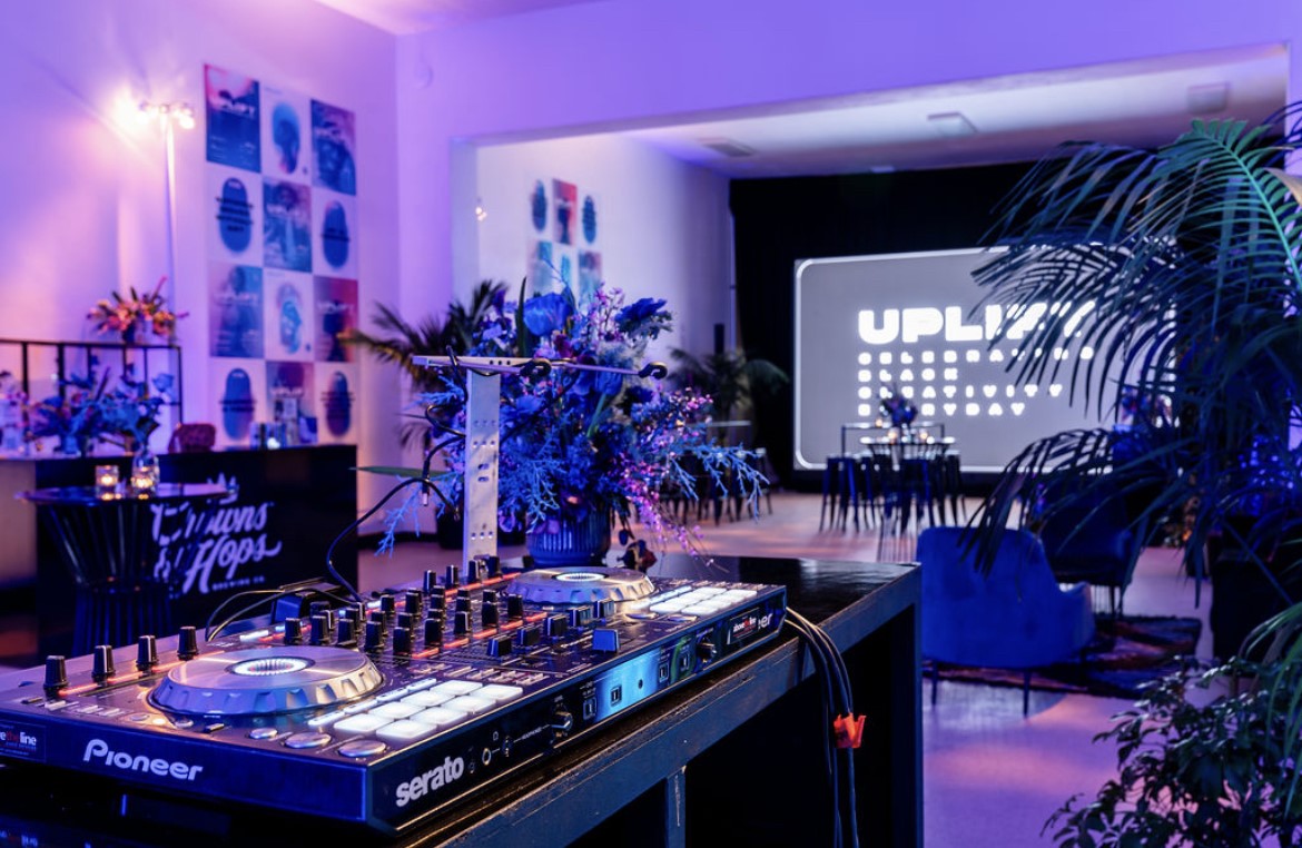 DJ setup indoors with colorful lights designed by Susan Houmes