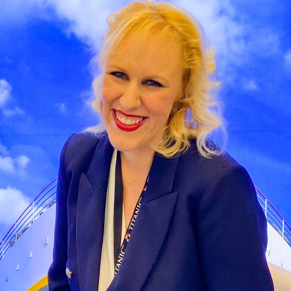 Loralei Llee wearing navy blue jacket with an image of the Tittanic ship behind her