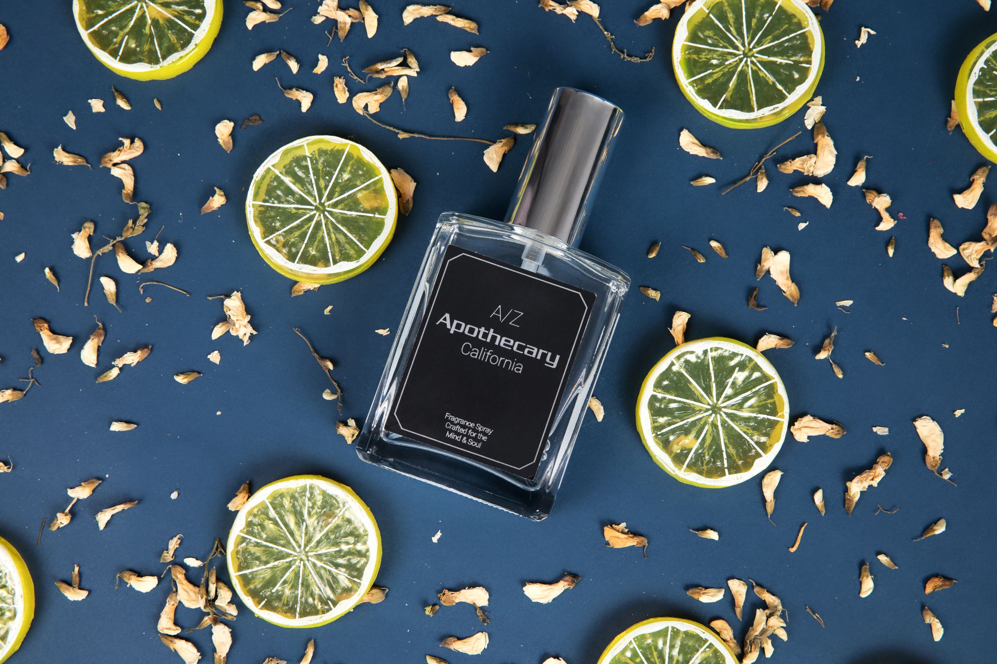 fragrance spray styled with slices of fresh lime sitting on a table