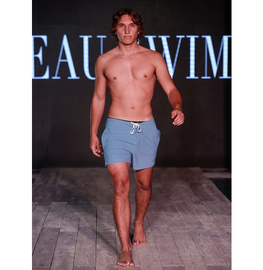 male model on the runway of a Beau Swim brand runway show wearing only swim shorts