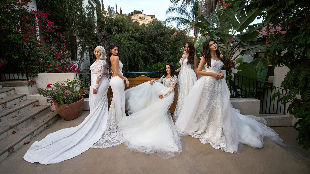 models wearing white wedding dresses as they pose outdoors
