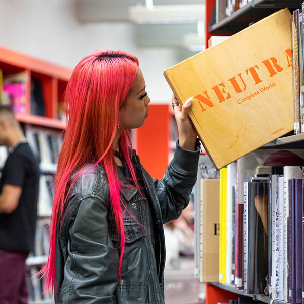 Student holding a book in the library