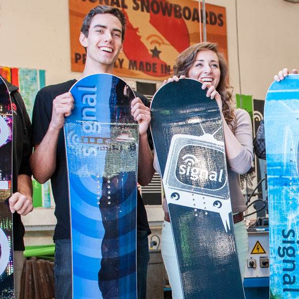 Students posing with the snowboards they designed