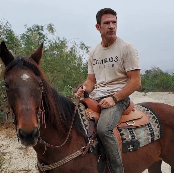 A behind the scenes still of an actor wearing Trinidad3 apparel while on horseback from the upcoming film MVP