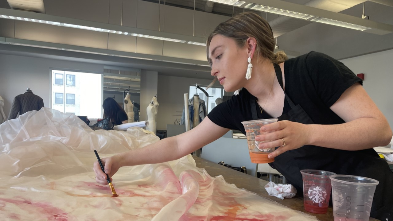 Susan Lizotte painting fabric by hand in a FIDM classroom
