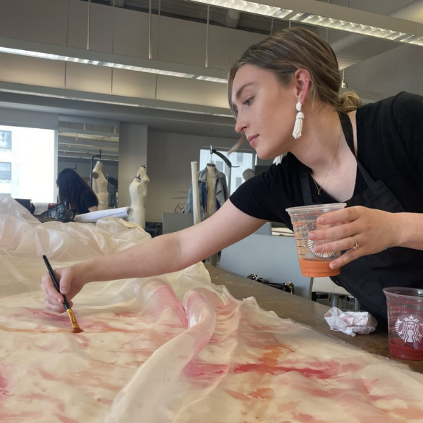 Susan Lizotte painting fabric by hand in a FIDM classroom