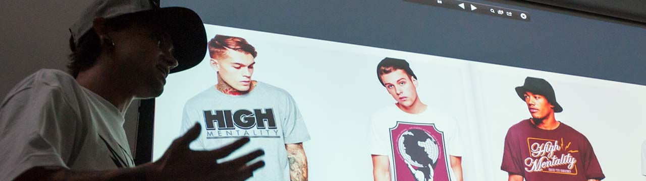 Student presenting graphic T-shirt designs