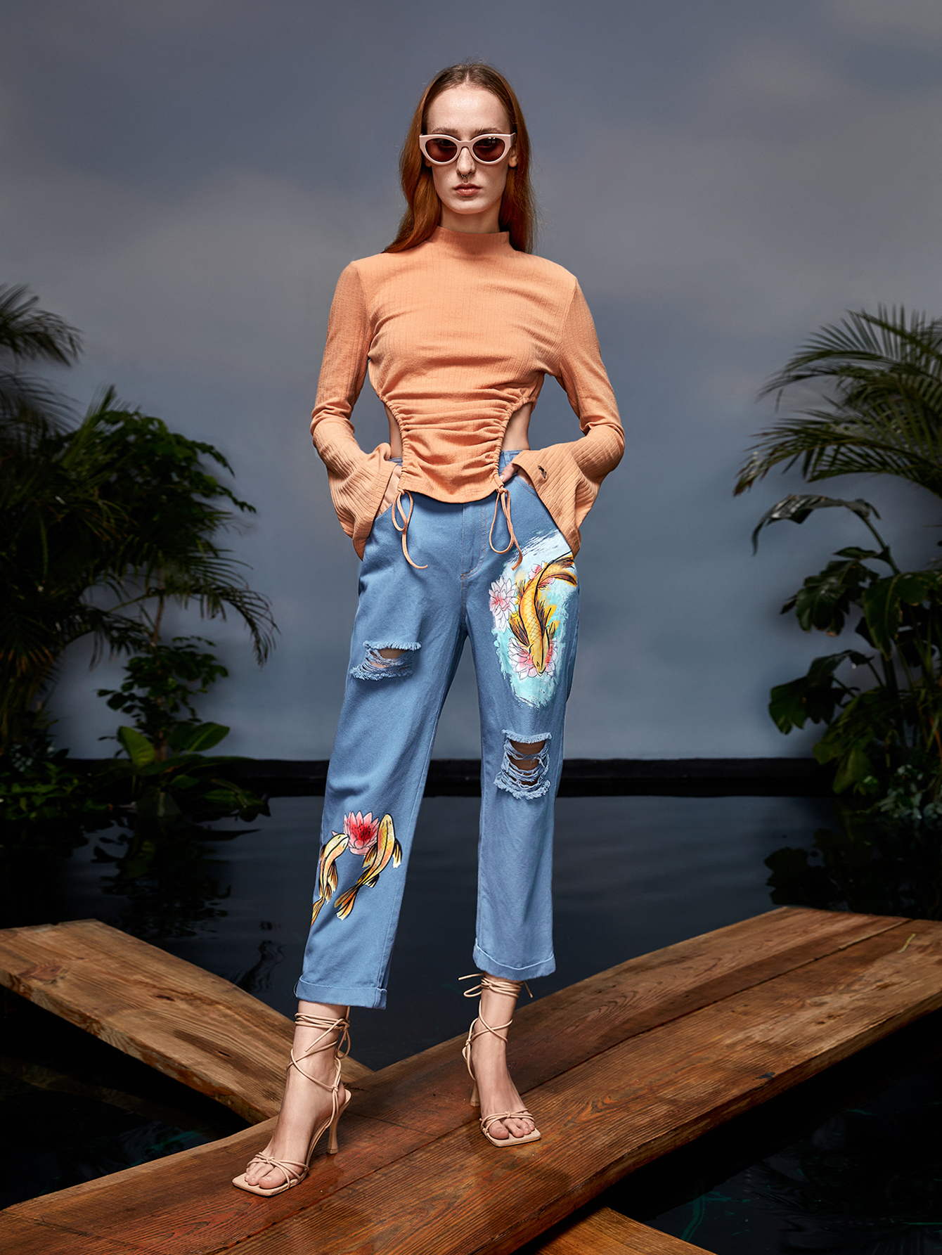 model wearing jeans with a fish print