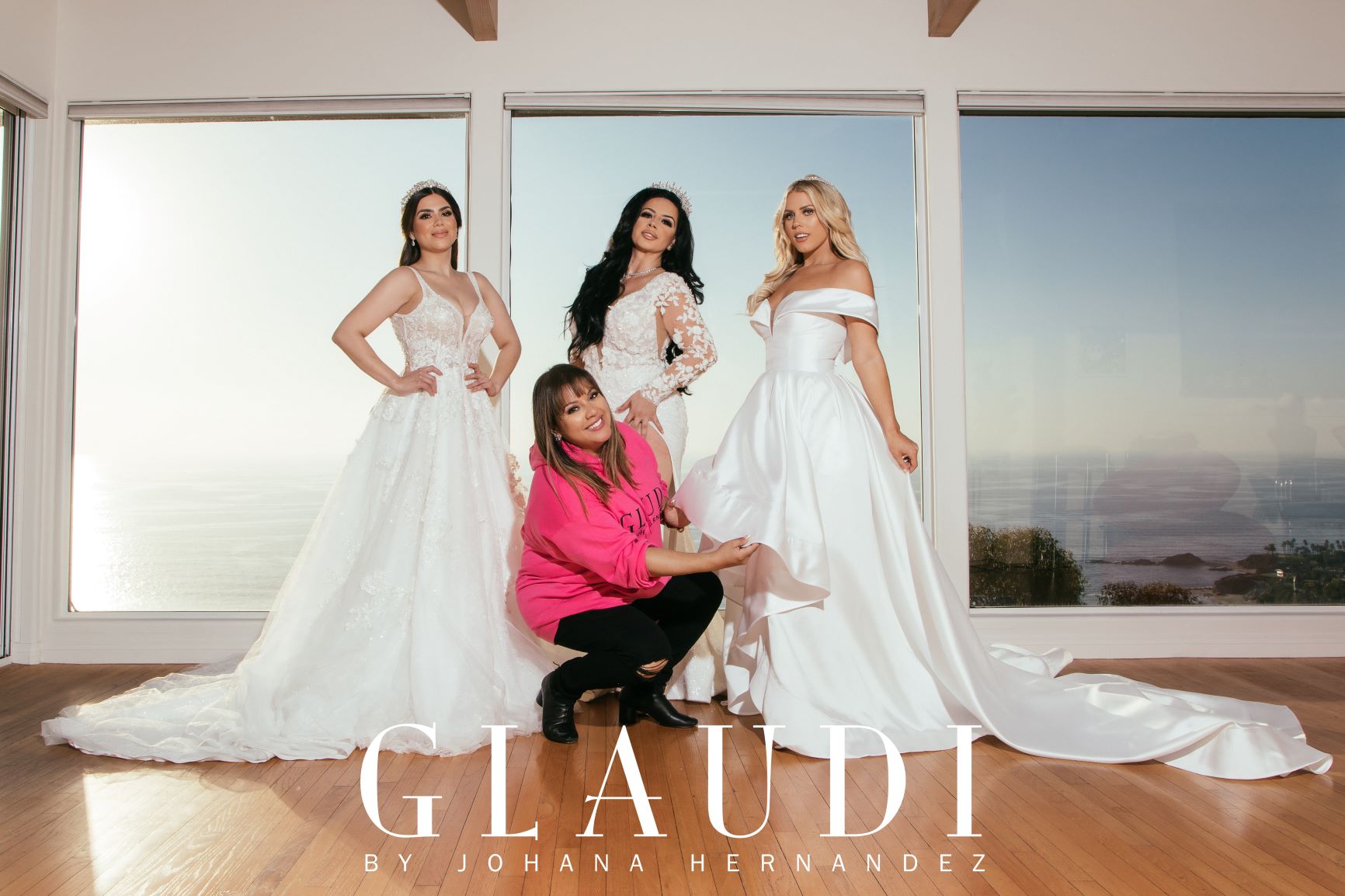 Designer Johana Hernandez poses with three models wear her bridal designs