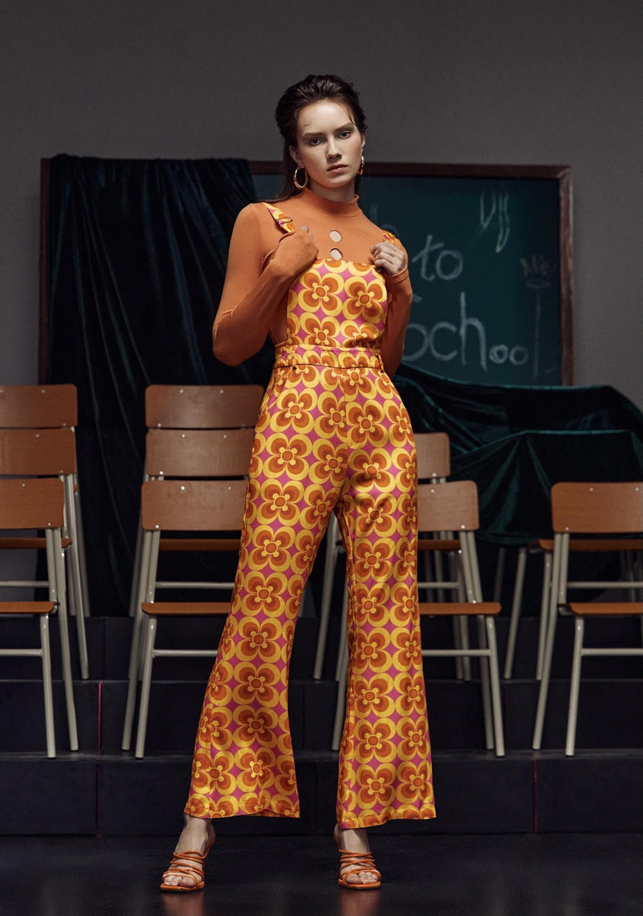 A model wears a graphic floral print jumpsuit with bellbottoms designed by FIDM Grad Simone Rogers