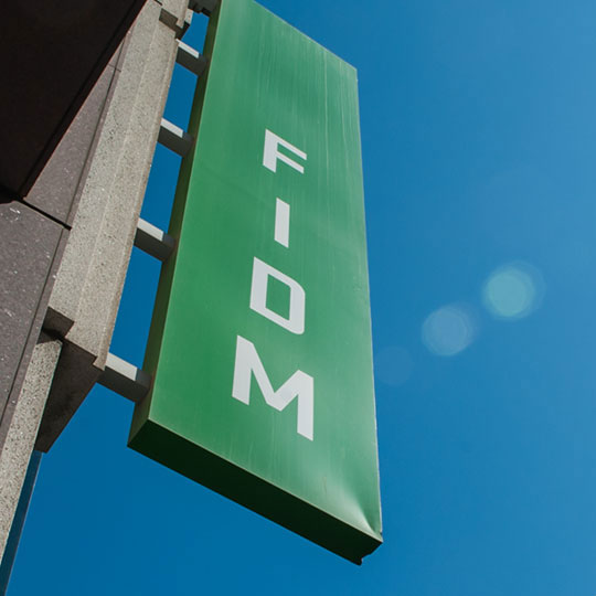 Green FIDM sign and building