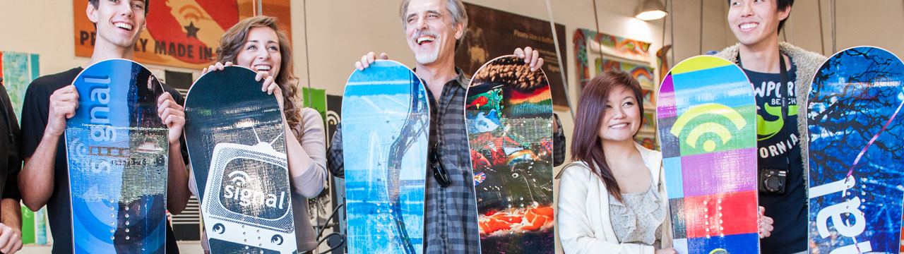 Students displaying the snowboards they designed