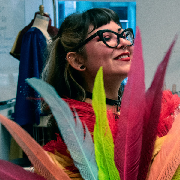 fashion design student working with colorful feathers