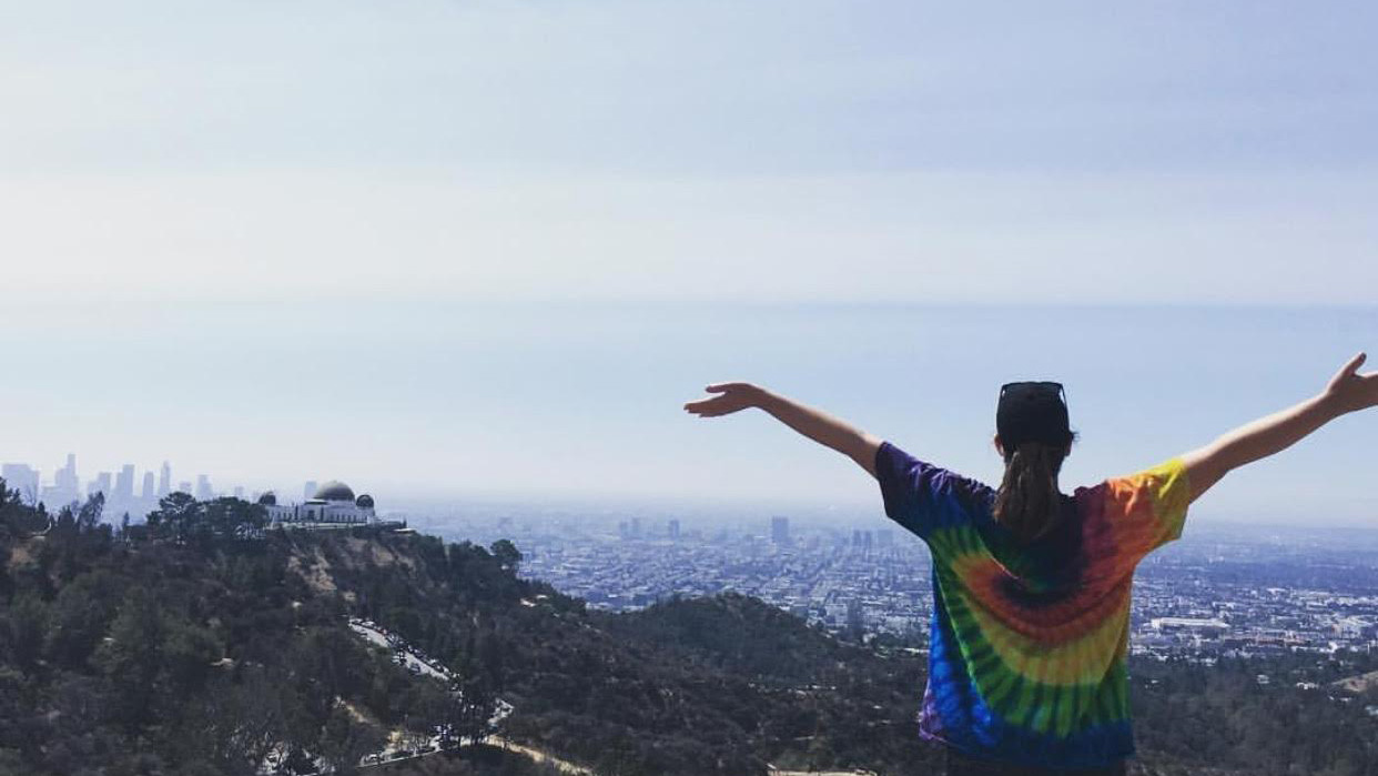 Student in a tie dye shirt enjoys the view from Griffith Park