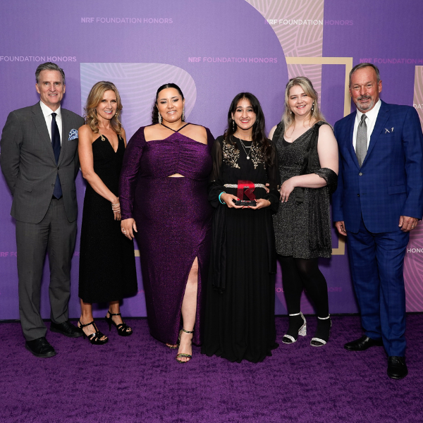 FIDM students stand on stage against purple background at NRF Foundation Student Challenge Honors night in New York City
