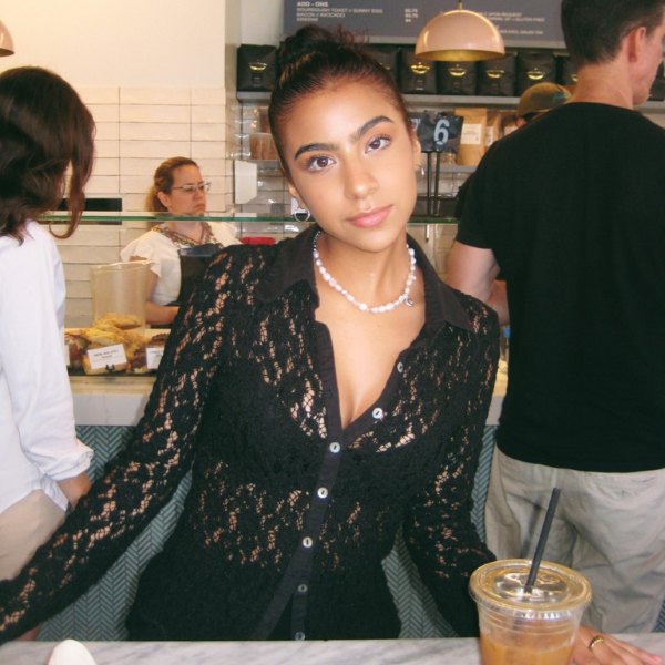 Karissa Butler wearing a black lace top indoors at a coffee shop